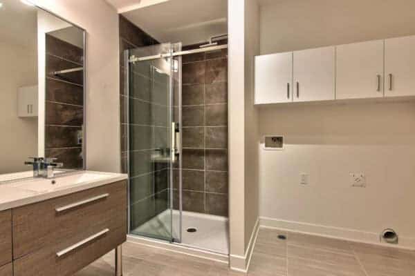 Salle de bain avec douche à l’italienne et rangement.