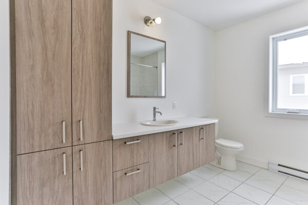 Appartement 2 chambres à Crabtree, idéal pour la gestion immobilière, avec salle de bain moderne, grand miroir, et espace lumineux. Parfait pour investisseurs ou locataires.