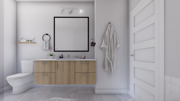 Vue d'une salle de bain moderne avec meuble en bois, miroir carré, toilette, et porte blanche, dans un appartement de Saint-Donat-de-Montcalm.